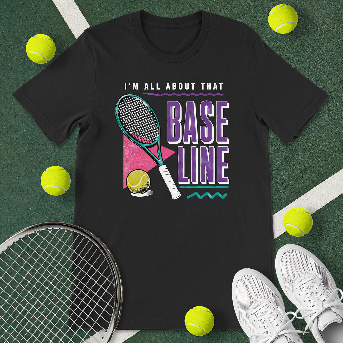 Black t-shirt with the text 'I'M ALL ABOUT THAT BASELINE' and a graphic of a tennis racket and tennis ball.