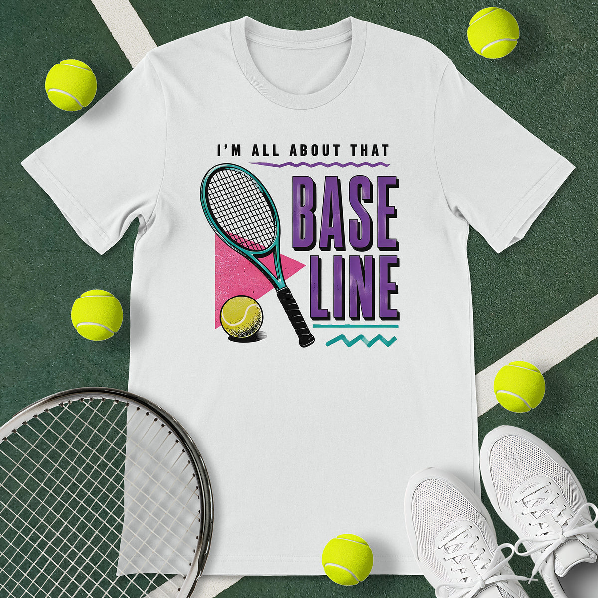 White t-shirt with the text 'I'M ALL ABOUT THAT BASELINE' and a graphic of a tennis racket and tennis ball.