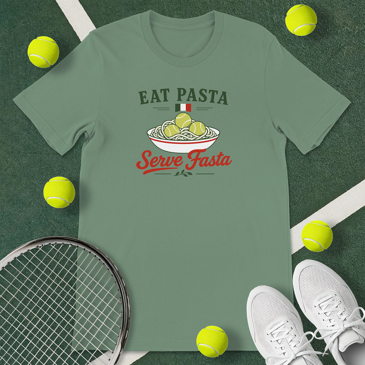 Sage green t-shirt with the text 'EAT PASTA Serve Fasta' and a graphic of a bowl of spaghetti with tennis balls instead of meatballs.