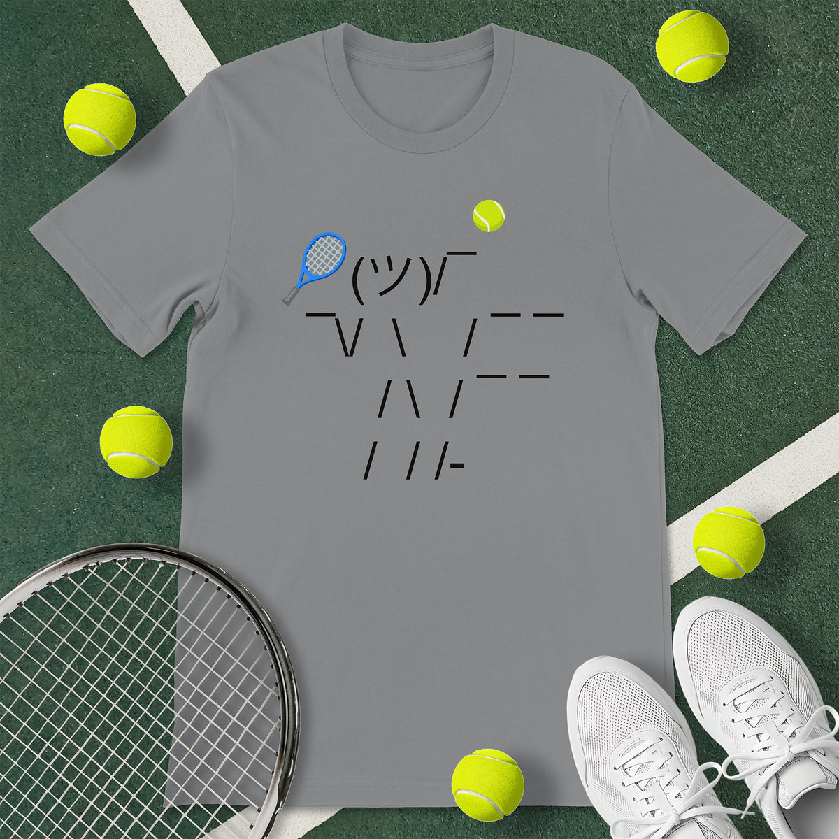 Grey t-shirt with a graphic of an emoticon. The emoticon is of a person serving a tennis ball. 