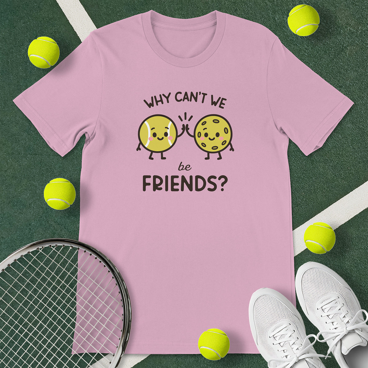Pink t-shirt with the text 'WHY CAN'T WE be FRIENDS' and a graphic of a bowl of a tennis ball high-fiving a pickleball.