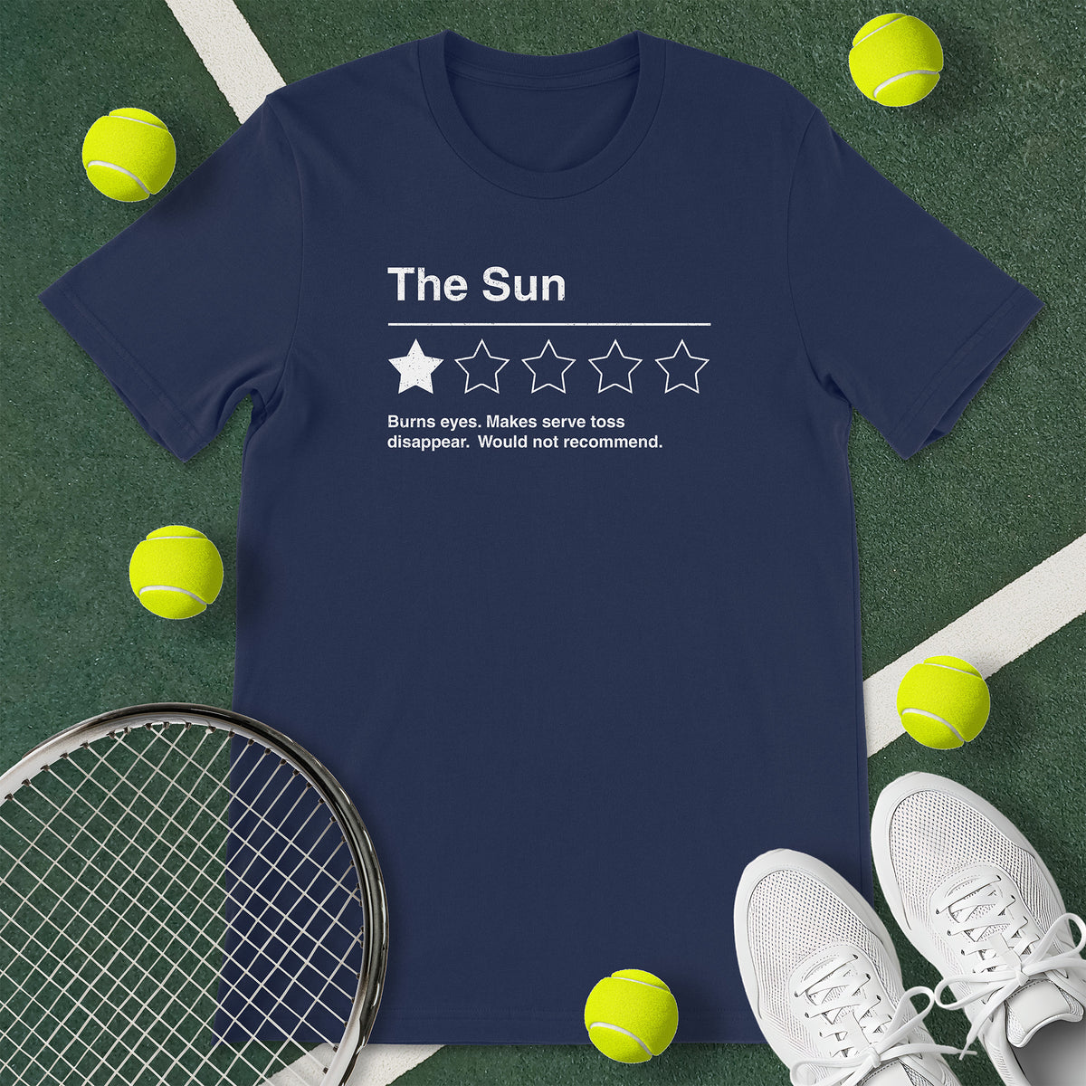 Navy blue t-shirt with the text 'The Sun - Burns eyes. Makes serve toss disappear. Would not recommend.' and a graphic of 1 star.